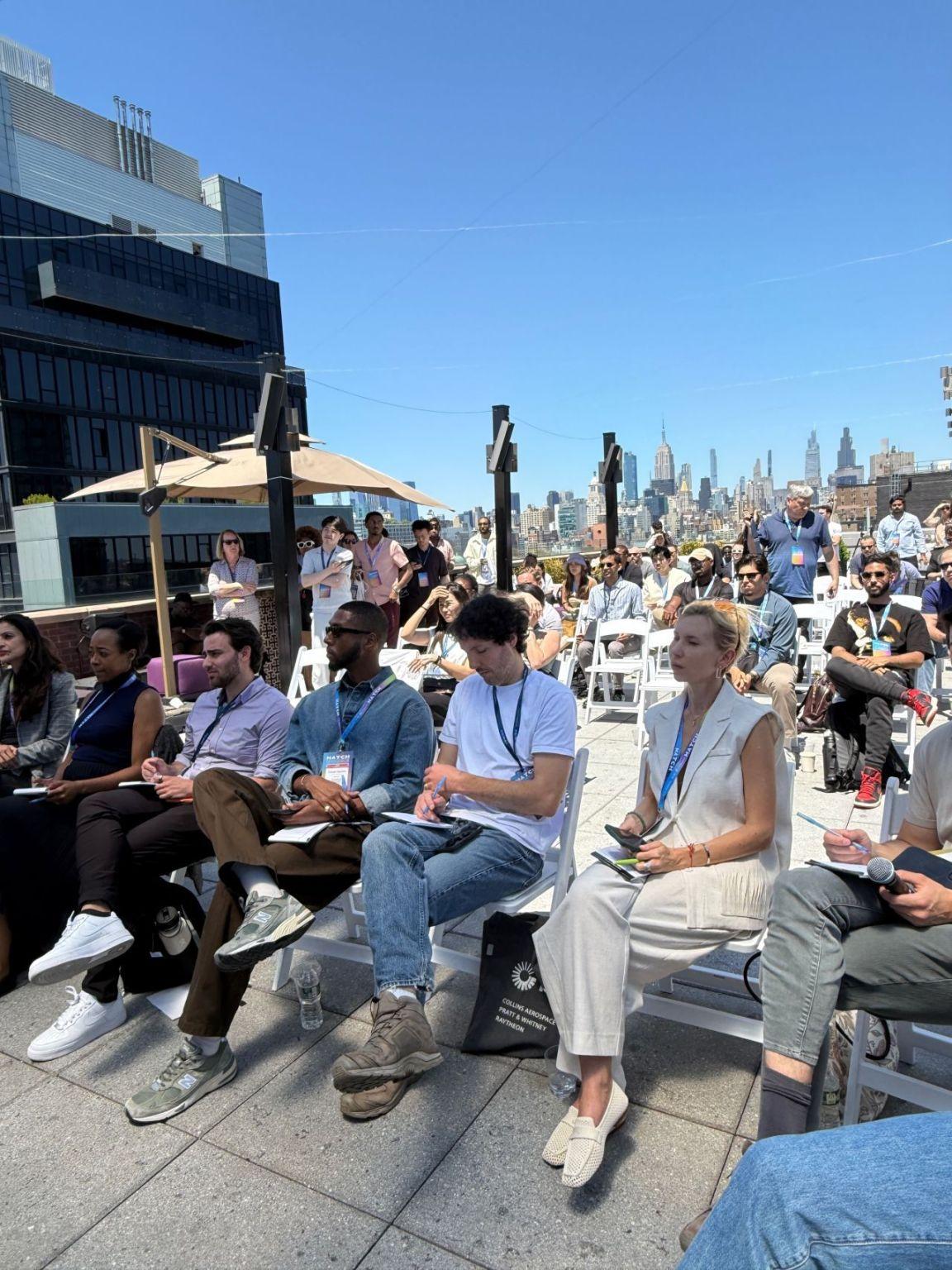 Judges, founders and guests seated at the rooftop pitch competition in New York